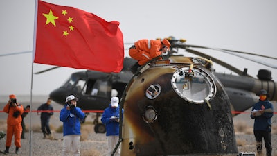 In this photo released by China's Xinhua News Agency, the return capsule of the Shenzhou-13 manned space mission is seen after landing at the Dongfeng landing site in northern China's Inner Mongolia Autonomous Region, April 16, 2022.