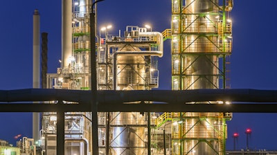 The facilities of the oil refinery on the industrial site of PCK-Raffinerie GmbH, jointly owned by Rosneft, are illuminated in the evening in Schwedt, Germany, on May 4, 2022.