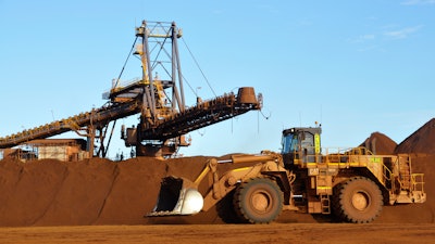 Earth moving equipment work at the site of Fortescue Metals Group's Christmas Creek iron ore operations in the Pilbara region of Western Australia, June 17, 2014.