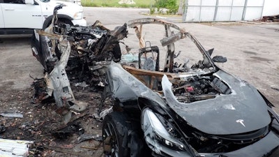 This image provided by the National Transportation Safety Board shows damage to a 2021 Tesla Model 3 Long Range Dual Motor electric car following a crash in September, 2021, in Coral Gables, Fla.