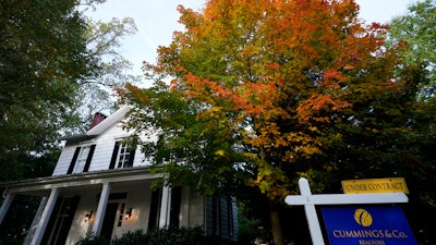 A real estate sign is seen near a home on the market in Towson, Md., Oct. 12, 2022.