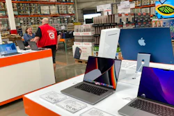 A sales associate helps a prospective customer as laptops sit on display in a Costco warehouse, Aug. 15, 2022, in Sheridn, Colo. Americans picked up their spending a bit in August from July even as surging inflation on household necessities like rent and food take a toll on household budgets. The U.S. retail sales rose an unexpected 0.3% last month, from being down 0.4% in July, the Commerce Department said Thursday., Sept. 15, 2022.