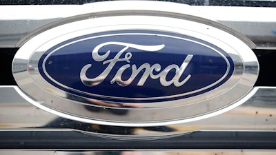 In this Oct. 20, 2019 file photograph, the company logo shines off the grille of an unsold vehicle at a Ford dealership in Littleton, Colo. Ford is recalling over 634,000 SUVs worldwide, Thursday, Nov. 24, 2022, because a cracked fuel injector can spill fuel or leak vapors onto a hot engine and cause fires. The recall covers Bronco Sport and Escape SUVs from the 2020 through 2023 model years with 1.5-liter, three-cylinder engines.
