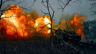 Ukrainian soldiers fire an artillery at Russian positions near Bakhmut, Donetsk region, Ukraine, Sunday, Nov. 20, 2022.