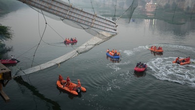 Search and rescue work is going on as a cable suspension bridge collapsed in Morbi town of western state Gujarat, India, Monday, Oct. 31, 2022.