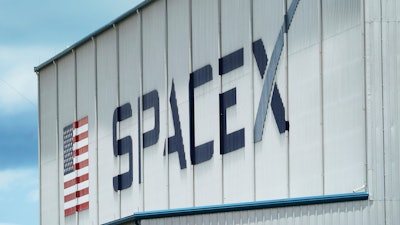 The SpaceX logo is displayed on a building, Tuesday, May 26, 2020, at the Kennedy Space Center in Cape Canaveral, Fla.
