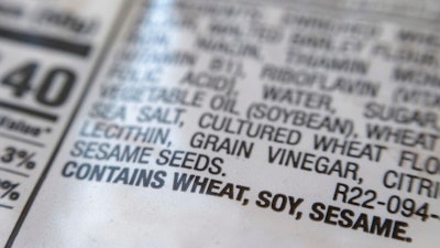A notification for sesame is printed under the ingredient list on a bag of hot dog buns in New York on Wednesday, Dec. 21, 2022. A new federal law requiring that sesame be listed as an allergen on food labels is having unintended consequences _ increasing the number of products that include the ingredient. Starting Jan. 1, all foods made and sold in the U.S. must be labeled if they contain sesame, an often-hidden ingredient that's been declared the nation's ninth major allergen.