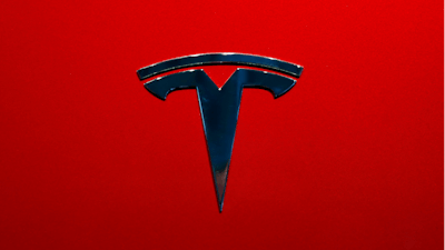 The logo of Tesla model 3 is seen at the Auto show on Oct. 3, 2018, in Paris.