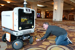 A member of the media films the Ottobot Yeti as it operates before the start of the CES tech show, Jan. 4, 2023, Las Vegas.