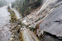 Rocks and vegetation cover Highway 70 following a landslide in the Dixie Fire zone, Plumas County, Calif., Oct. 24, 2021.