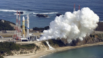 An H3 rocket sits on the launch pad next to billowing white smoke at Tanegashima Space Center in Kagoshima, southern Japan Friday, Feb. 17, 2023.