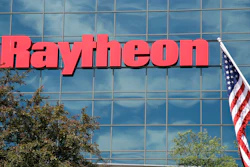 An American flag flies in front of the façade of Raytheon's Integrated Defense Systems facility, in Woburn, Mass on June 10, 2019.