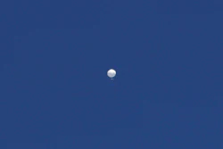 A balloon floats over Columbia, Mo., on Feb. 3, 2023. The United States on Friday, Feb. 10 blacklisted six Chinese entities it said were linked to Beijing's aerospace programs as part of its retaliation over an alleged Chinese spy balloon that traversed the country's airspace. (Anna Griffin/Missourian via AP, File)