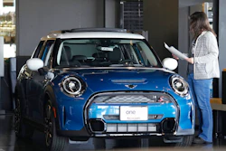 A potential buyer looks over a 2023 Cooper S sedan on the floor of a Mini dealership Friday, Feb. 17, 2023, in Highlands Ranch, Colo. Over the past year, the Fed has raised its key short-term rate eight times, causing many kinds of consumer and business loans, including auto loans, to become more expensive.