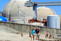People walk on the sand near the shuttered San Onofre nuclear power plant in San Clemente, Calif., on June 30, 2011. The U.S. government has long struggled to find a permanent solution for storing or disposing of spent nuclear fuel generated by the nation's commercial nuclear power plants, and opposition in the Southwestern U.S. is flaring up again as New Mexico lawmakers debated a bill that would ban construction of such a facility without state consent.