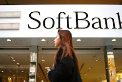 A woman walks in front of SoftBank store in Ginza shopping district in Tokyo, Jan. 20, 2020. Japanese investor SoftBank Group reported Tuesday, Feb. 7, 2023 that it sank into a deep loss for the October-December quarter, slammed by the global plunge in technology shares.