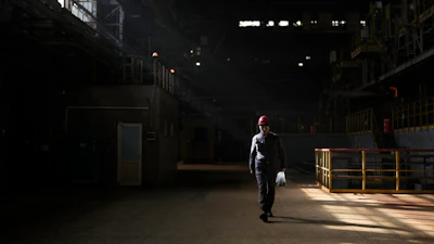 A worker walks inside the Zaporizhstal steel plant, in Zaporizhia, Ukraine, Wednesday, March 1, 2023.