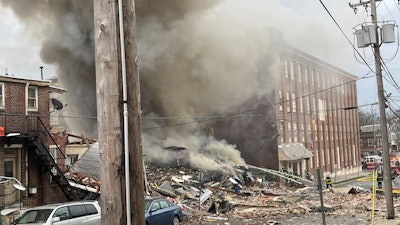 Emergency personnel work at the site of a deadly explosion at a chocolate factory in West Reading, Pa., March 24, 2023.