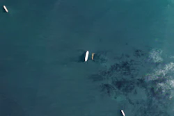 In this satellite photo by Planet Labs PBC, the oil tankers the Oceania, center left, and the Abyss, center right, are seen in the Malacca Strait between Indonesia and Malaysia on Tuesday, March 28, 2023. The Oceania, owned by a major U.S.-traded transportation company, appears to be taking on Iranian crude oil in a key Asian maritime strait in violation of American sanctions, an advocacy group alleges.