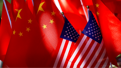 The flags of the U.S. and Chinese are displayed together on top of a trishaw in Beijing on Sept. 16, 2018.