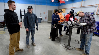 Payton Lane, 19, left, and Boone Williams, 20, talk during a second-year apprentice training program class at the Plumbers and Pipefitters Local Union 572 facility in Nashville, Tenn., on Thursday, Feb. 2, 2023.
