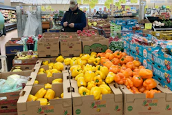 A man looks at his mobile phone while shopping at a grocery store in Buffalo Grove, Ill., Sunday, March 19, 2023. On Wednesday, the Labor Department reports on U.S. consumer prices for March.