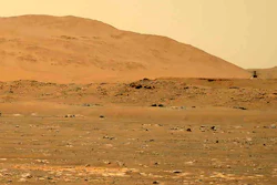 In this April 30, 2021, file image taken by the Mars Perseverance rover and made available by NASA, the Mars Ingenuity helicopter, right, flies over the surface of the planet.