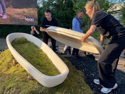 Director Lonneke Westhoff, right, and founder Bob Hendrikx, left, of Dutch startup Loop Biotech display one of the cocoon-like coffins, grown from local mushrooms and up-cycled hemp fibres, designed to dissolve into the environment amid growing demand for more sustainable burial practices, in Delft, Netherlands, Monday, May 22, 2023.