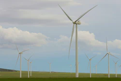 Wind turbines stand at a wind farm along the Montana-Wyoming state line on June 13, 2022.