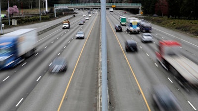Cars and trucks travel on Interstate 5 near Olympia, Wash., March 25, 2019. The government’s traffic safety agency said Thursday, June 22, 2023, that it will require heavy trucks and buses to include potentially life-saving automatic emergency braking equipment within five years. Automatic braking systems in heavy vehicles would prevent nearly 20,000 crashes a year and save at least 155 lives, the National Highway Traffic Safety Administration said.