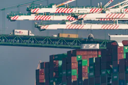 Transportation trucks cross the Vincent Thomas Bridge over the main channel as shipping containers are seen stacked on the Evergreen terminal at the Port of Los Angeles in San Pedro, Calif., Nov. 30, 2021. The union for thousands of West Coast dockworkers has reached a tentative agreement on a new contract, it was announced Wednesday, June 14, 2023, after more than a year of negotiations and several work disruptions that snarled shipping traffic at some of the largest ports.