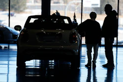 Shoppers consider a 2022 Cooper convertible on display in a Mini dealership in Highlands Ranch, Colo., on Friday, Feb. 18, 2022.