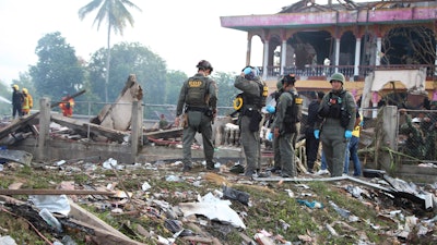 Thai Explosive Ordnance Disposal (EOD) personnel examine the site of an explosion at a firework warehouse in Narathiwat province southern Thailand, Saturday, July 29, 2023.