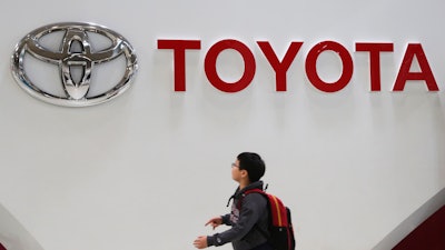 A boy looks at a logo of Toyota Motor Corp. at its gallery in Tokyo on Jan. 15, 2020.