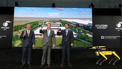 Chung Eui-sun, left, executive chairman of Hyundai Motor Group, Georgia Gov. Brian Kemp, and Jose Munoz, president and COO of Hyundai, celebrate with a champagne toast during the official groundbreaking for the Hyundai Meta Plant on Oct. 25, 2022 in Ellabell, Ga.