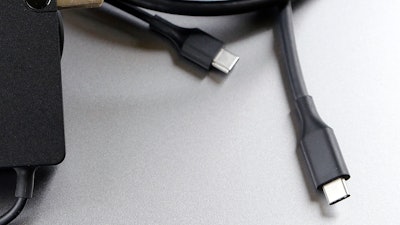 A USB-C cable is pictured in San Jose, Calif. Tuesday, March 10, 2015. Apple is ditching its in-house iPhone charging plug and falling in line with the rest of the tech industry by adopting USB-C, a more widely used connection standard.