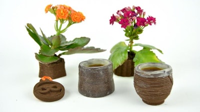 A pendant, espresso cups and flower planters 3D printed from used coffee grounds.