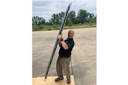 Pablo Zavattieri, the Jerry M. and Lynda T. Engelhardt Professor in Civil Engineering, lifts an aircraft runway mat made with new intelligent architected materials developed at Purdue University.