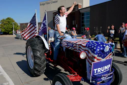 Gary Leffler drives his tractor past supporters before the arrival of former President Donald Trump at a rally, Sunday, Oct. 1, 2023, in Ottumwa, Iowa.