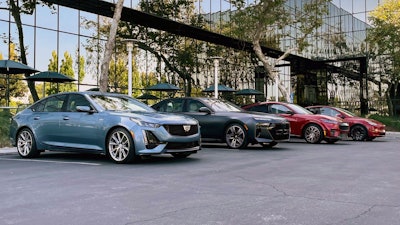 This photo provided by Edmunds shows the BMW i7, Cadillac CT5-V, Ford Mustang Mach-E and Tesla Model Y.
