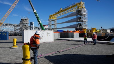 A generator and its blades are prepared at State Pier in New London, Conn., Monday, Dec. 4, 2023, to head to the ocean for the South Fork Wind farm.