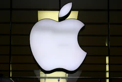 The Apple logo is illuminated at a store in the city center of Munich, Germany, Dec. 16, 2020.