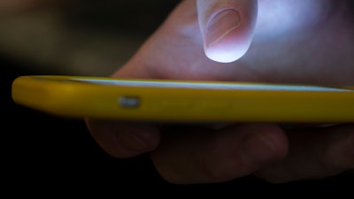 A man uses a cell phone in New Orleans on Aug. 11, 2019.