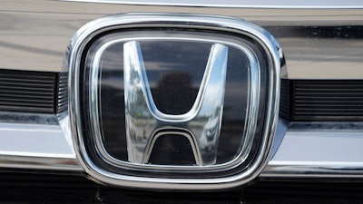 The Honda company logo is shown outside a Honda dealership Sunday, Sept. 12, 2021, in Highlands Ranch, Colo.