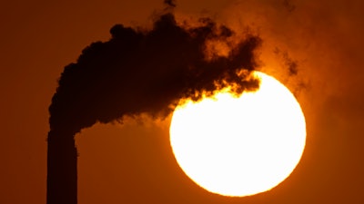 Emissions rise from the smokestacks at the Jeffrey Energy Center coal power plant as the suns sets Sept. 18, 2021, near Emmett, Kan.