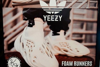A sign advertises Yeezy shoes made by Adidas at Kickclusive, a sneaker resale store, in Paramus, N.J., on Oct. 25, 2022.