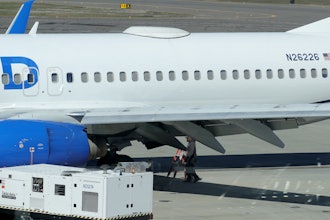 A Medford Jet Center worker walks under a United Boeing 737-824 that landed at Rogue Valley International-Medford Airport from San Francisco with a missing panel Friday, March 15, 2024, in Medford, Ore.