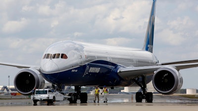 In this Friday, March 31, 2017, file photo, Boeing employees walk the new Boeing 787-10 Dreamliner down towards the delivery ramp area at the company's facility in South Carolina after conducting its first test flight at Charleston International Airport in North Charleston, S.C.