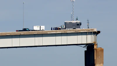 People work on a standing section of the collapsed Francis Scott Key Bridge, Monday, April 15, 2024, in Baltimore.