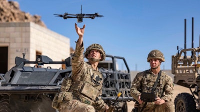 In this photo from the Defense Visual Information Distribution Service, British soldiers launch a drone during Project Convergence exercises at Fort Irwin, Calif., on Nov. 4, 2022.